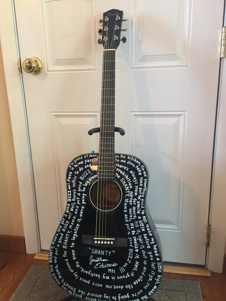 Black Fender guitar with lyrics